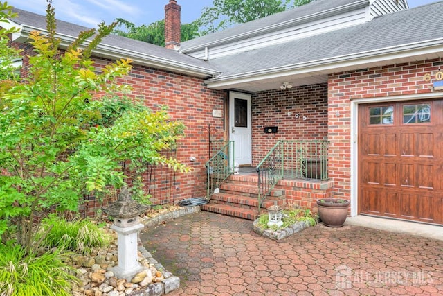 605 Beechwood Ave, Middlesex, NJ 08846 - doorway to property featuring brick siding, a chimney, and a shingled roof