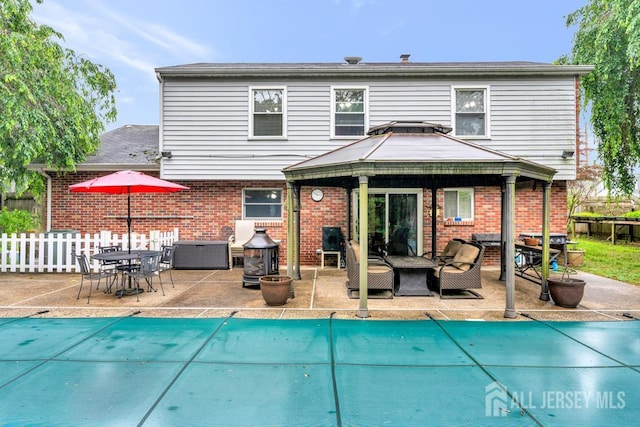 605 Beechwood Ave, Middlesex, NJ 08846 - rear view of house featuring a gazebo, brick siding, a patio, and an outdoor living space