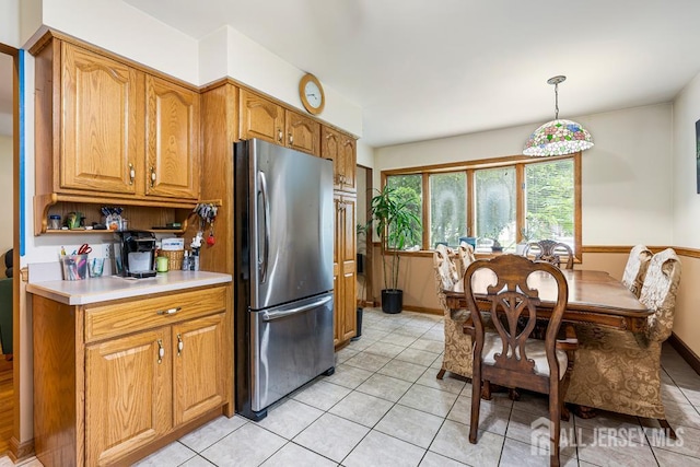 605 Beechwood Ave, Middlesex, NJ 08846 - kitchen with freestanding refrigerator, light tile patterned floors, light countertops, and brown cabinets