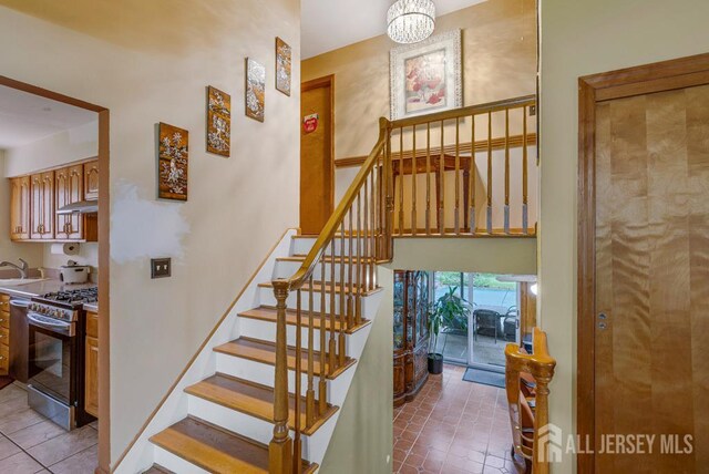 605 Beechwood Ave, Middlesex, NJ 08846 - stairs featuring tile patterned flooring and a chandelier