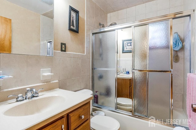 605 Beechwood Ave, Middlesex, NJ 08846 - bathroom featuring tile walls, vanity, and enclosed tub / shower combo
