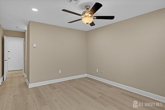 empty room featuring light wood-type flooring and ceiling fan