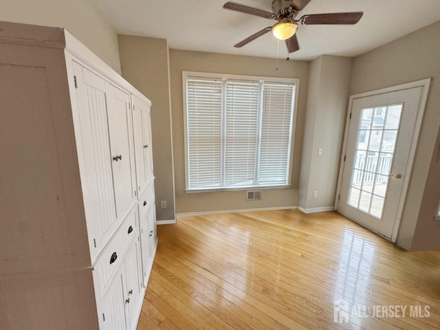 51 S Shore Dr, South Amboy, NJ 08879 - unfurnished bedroom with light wood-style flooring, baseboards, ceiling fan, and access to exterior