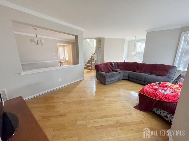 51 S Shore Dr, South Amboy, NJ 08879 - living room with ornamental molding, a chandelier, stairway, wood finished floors, and baseboards