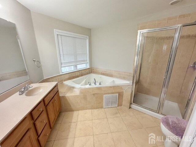 51 S Shore Dr, South Amboy, NJ 08879 - bathroom featuring vanity, a garden tub, tile patterned floors, a stall shower, and toilet