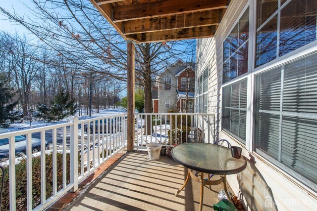 view of snow covered back of property