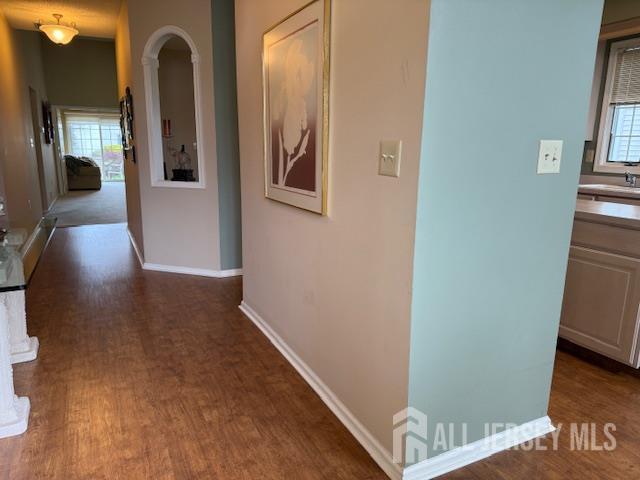 102 Leeds Ln, Monroe, NJ 08831 - hallway with healthy amount of natural light, arched walkways, and dark wood finished floors