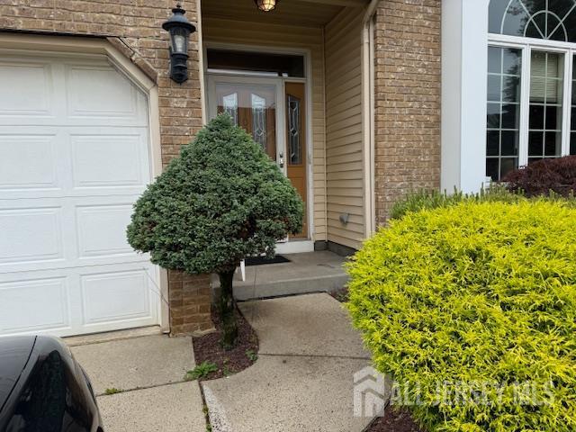 102 Leeds Ln, Monroe, NJ 08831 - view of exterior entry featuring covered porch and a garage
