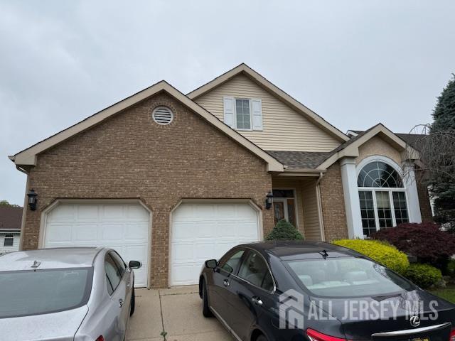 102 Leeds Ln, Monroe, NJ 08831 - traditional-style house with brick siding, concrete driveway, an attached garage, and roof with shingles