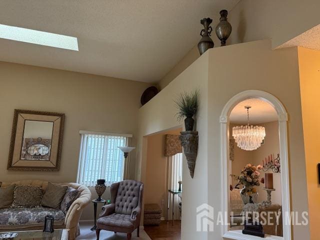 102 Leeds Ln, Monroe, NJ 08831 - sitting room featuring arched walkways, a chandelier, wood finished floors, and a skylight