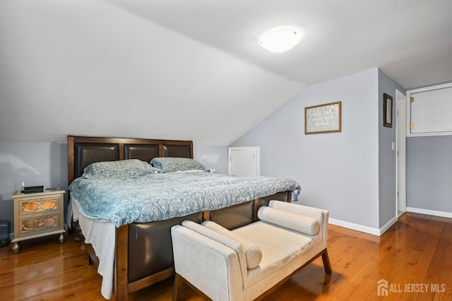 bedroom featuring lofted ceiling and wood-type flooring