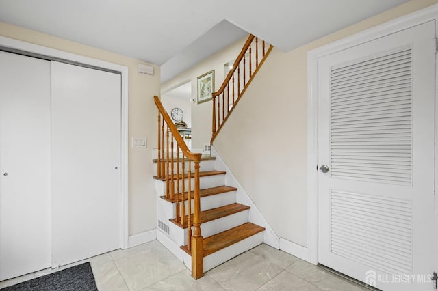 stairs featuring tile patterned floors