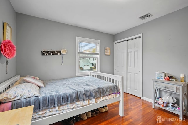 bedroom featuring hardwood / wood-style flooring and a closet