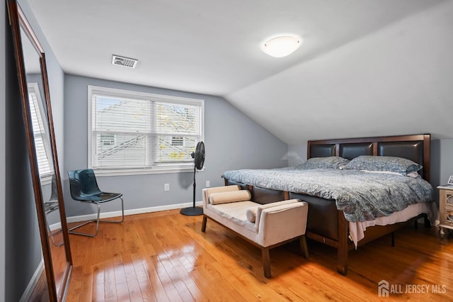 bedroom featuring vaulted ceiling and light hardwood / wood-style flooring