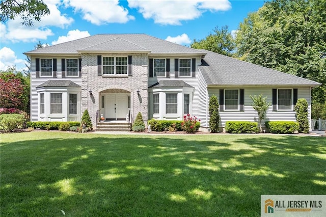 21 Tanglewood Pl, Monroe, NJ 08831 - view of front of house with a front yard and a shingled roof