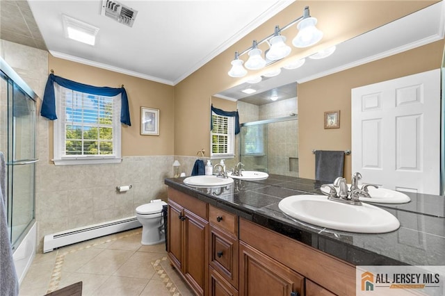 21 Tanglewood Pl, Monroe, NJ 08831 - bathroom with baseboard heating, tile patterned flooring, tile walls, double vanity, and healthy amount of natural light