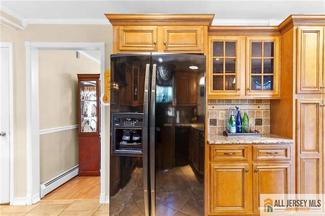 21 Tanglewood Pl, Monroe, NJ 08831 - kitchen featuring black fridge, baseboard heating, light stone countertops, decorative backsplash, and crown molding