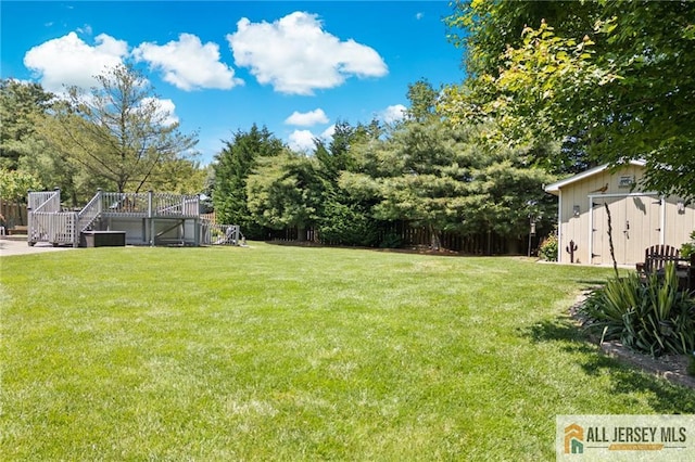 21 Tanglewood Pl, Monroe, NJ 08831 - view of green lawn featuring stairway, a deck, and a storage shed