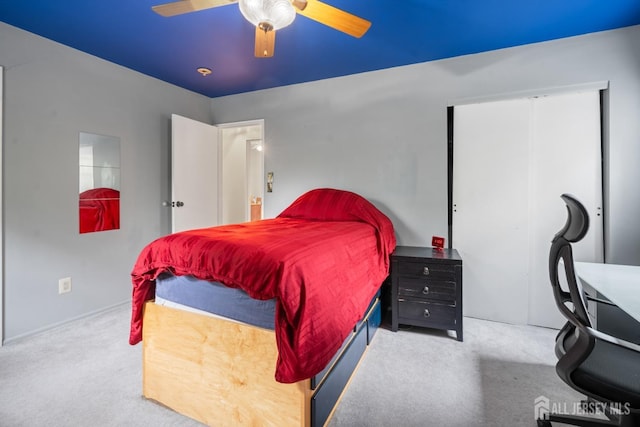 carpeted bedroom with a closet and ceiling fan