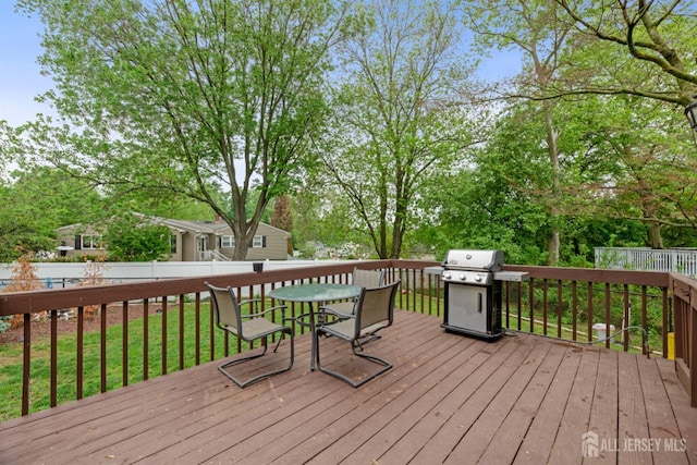 wooden terrace featuring a grill