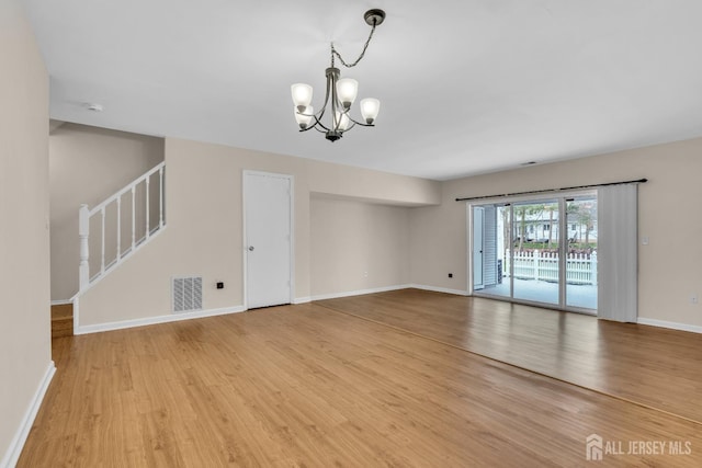19 Albury Way N, Brunswick, NJ 08902 - spare room featuring a chandelier, light wood-style floors, baseboards, and stairs