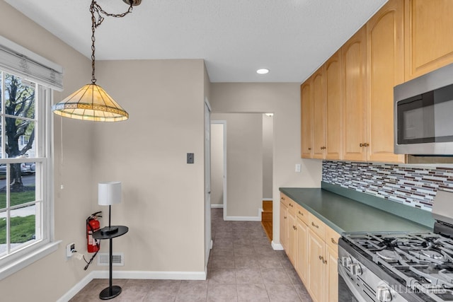 19 Albury Way N, Brunswick, NJ 08902 - kitchen featuring appliances with stainless steel finishes, baseboards, decorative backsplash, light tile patterned floors, and hanging light fixtures