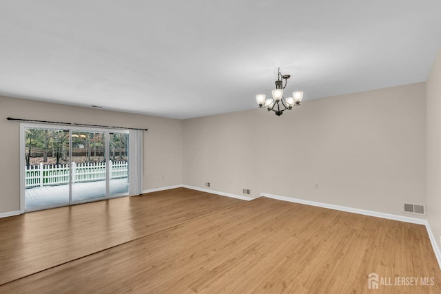 19 Albury Way N, Brunswick, NJ 08902 - unfurnished room with a chandelier, baseboards, and wood finished floors