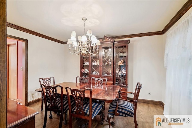 1 Eileen Ct, East Brunswick, NJ 08816 - dining space featuring a chandelier, wood finished floors, and ornamental molding