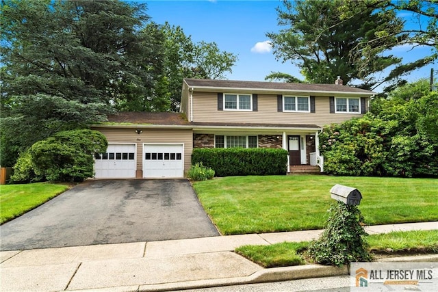 1 Eileen Ct, East Brunswick, NJ 08816 - view of front of home featuring a garage, asphalt driveway, a front yard, and a chimney