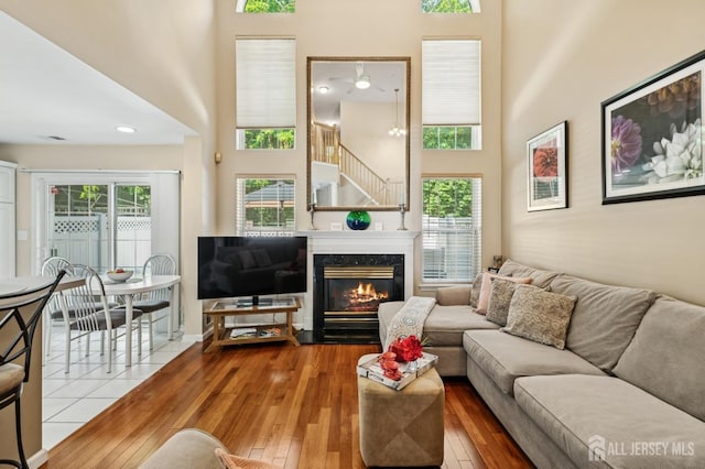 44 Windsong Cir E, Brunswick, NJ 08816 - living room with a high ceiling, hardwood / wood-style floors, plenty of natural light, and a premium fireplace