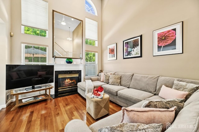 44 Windsong Cir E, Brunswick, NJ 08816 - living room with a high ceiling, wood finished floors, and a high end fireplace