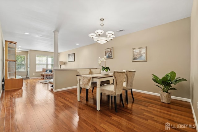 44 Windsong Cir E, Brunswick, NJ 08816 - dining space with hardwood / wood-style flooring, a chandelier, and decorative columns