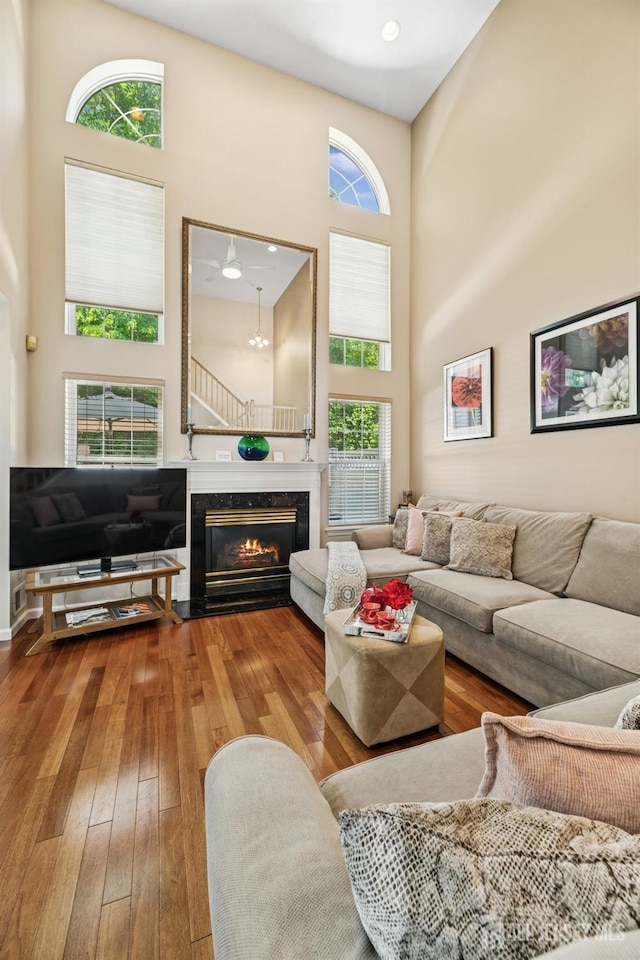 44 Windsong Cir E, Brunswick, NJ 08816 - living area with a high ceiling, healthy amount of natural light, wood-type flooring, and a fireplace