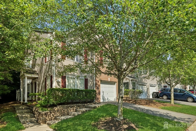 44 Windsong Cir E, Brunswick, NJ 08816 - obstructed view of property with a garage, driveway, and brick siding