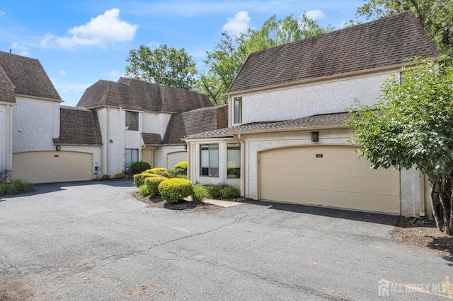 47 Park Gate Dr, Edison, NJ 08820 - view of front of home with roof with shingles, asphalt driveway, and stucco siding