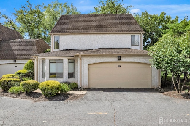 47 Park Gate Dr, Edison, NJ 08820 - view of front of home featuring stucco siding, asphalt driveway, and roof with shingles