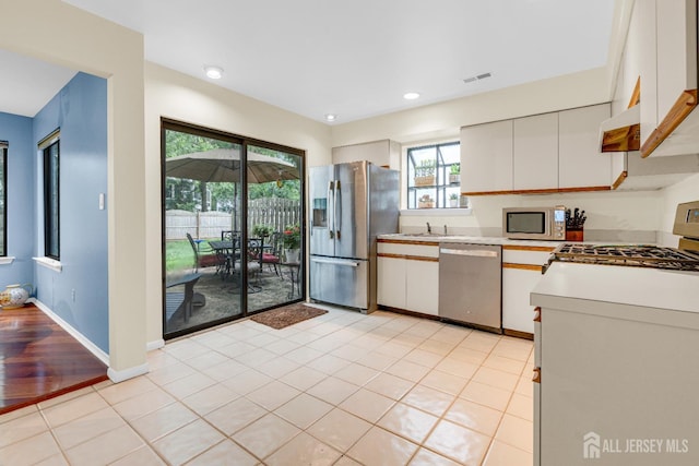 47 Park Gate Dr, Edison, NJ 08820 - kitchen with appliances with stainless steel finishes, light countertops, white cabinetry, recessed lighting, and light tile patterned floors