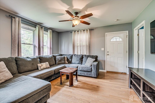 living room featuring plenty of natural light, light wood-style flooring, and ceiling fan