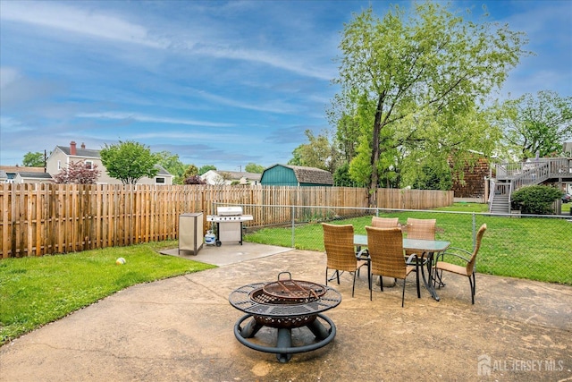view of patio with a fire pit, outdoor dining area, and a grill