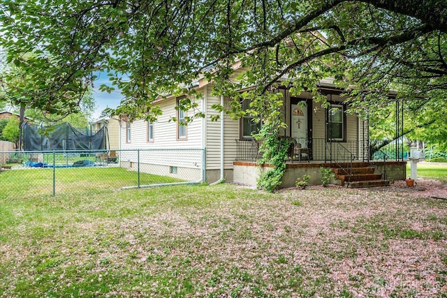 view of home's exterior with a trampoline and a porch