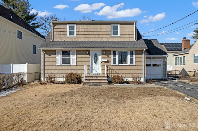 view of front of home with an attached garage, fence, aphalt driveway, and roof with shingles