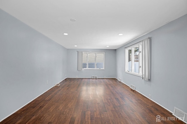 empty room featuring visible vents, wood finished floors, and recessed lighting