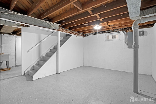 basement with stairway and a sink