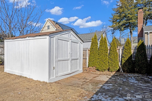 view of shed with fence