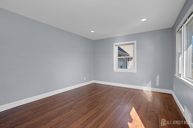 unfurnished room featuring dark wood-style floors, recessed lighting, visible vents, and baseboards