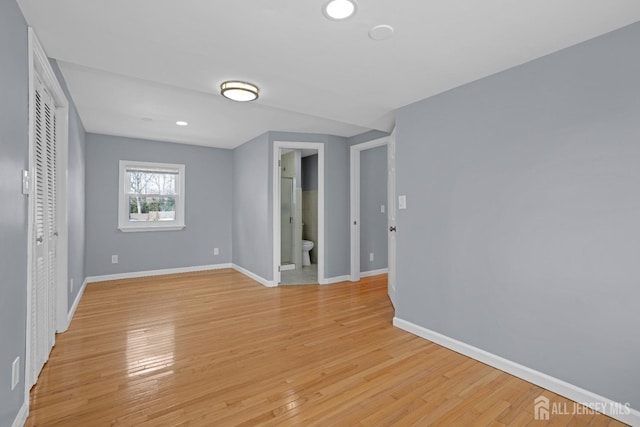 unfurnished room featuring light wood-style flooring, baseboards, and recessed lighting