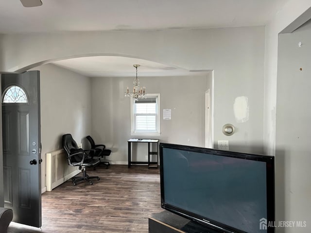 dining space featuring dark hardwood / wood-style flooring and a chandelier