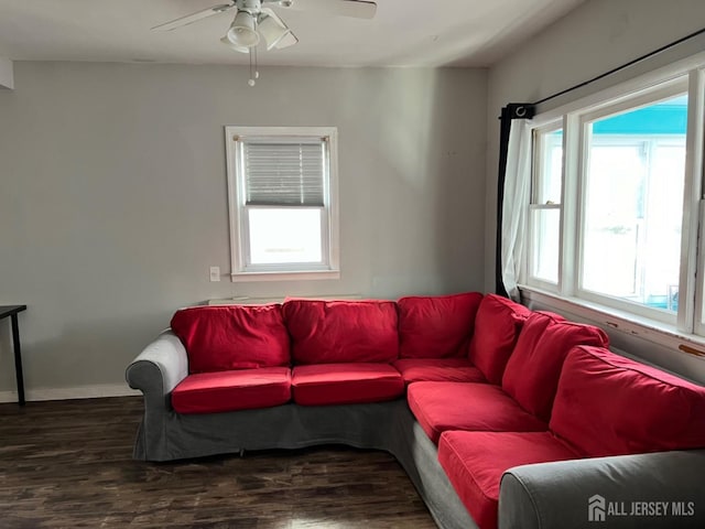 living room with dark wood-type flooring and ceiling fan