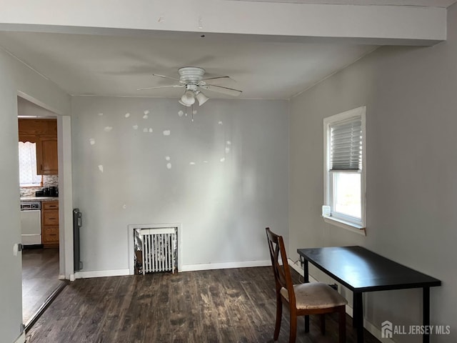 dining area featuring baseboards, dark wood finished floors, and a ceiling fan