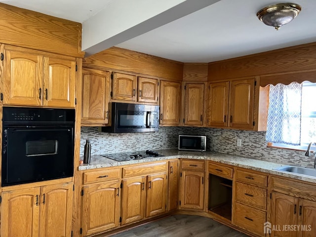 kitchen with sink, decorative backsplash, black appliances, and dark hardwood / wood-style floors